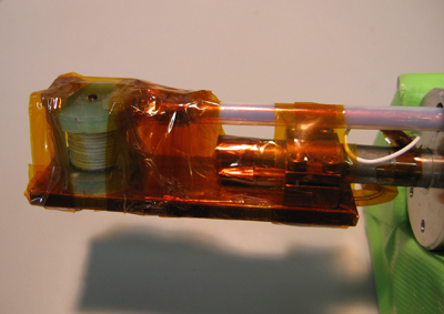 Fig. 1 Miniature pulsed magnet mounted on the edge of cooling device. The inner diameter is as small as 3 mm.